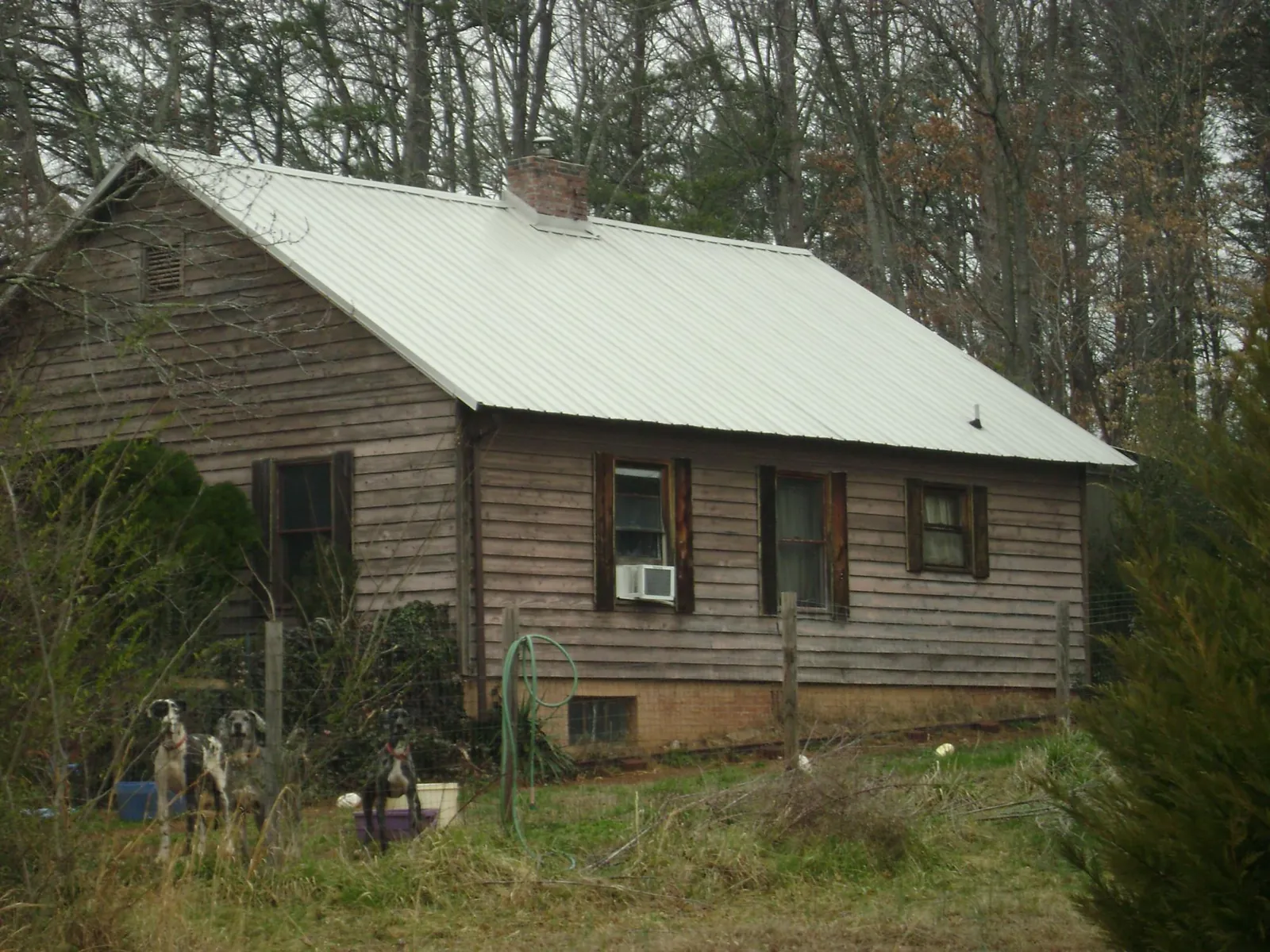 White metal roof on an old wood sided farmhouse, from a Metal Roof Installation job in Brandywine